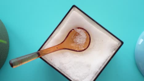 un batidor de sal con una cuchara pequeña en el interior