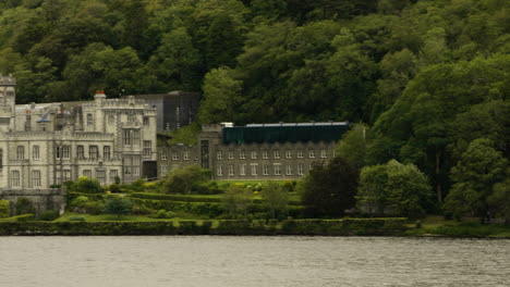 waterside gothic architecture of kylemore abbey and victorian walled garden in ireland