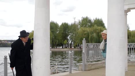 elderly couple's playful encounter by the lake