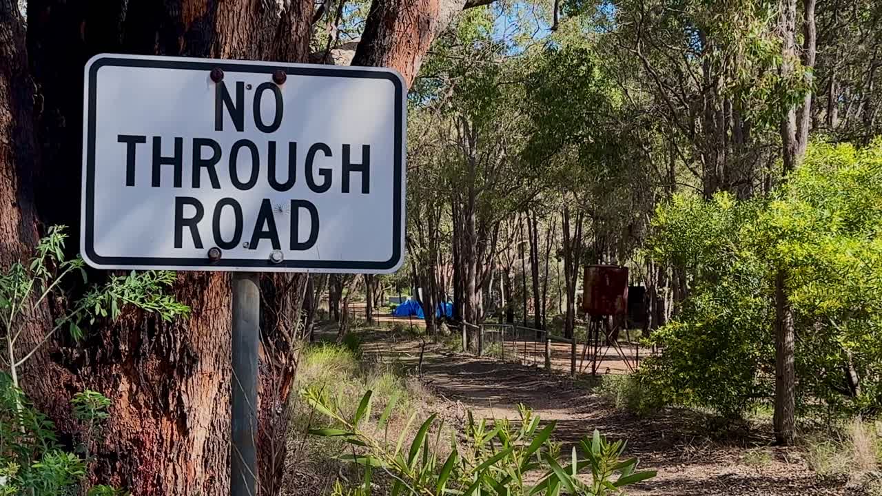 No Through Road Sign closeup Western Australian bush trail Glen Forest National Park trees