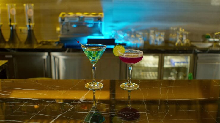 Hand of man leaving his drink on bar counter next to his partner's