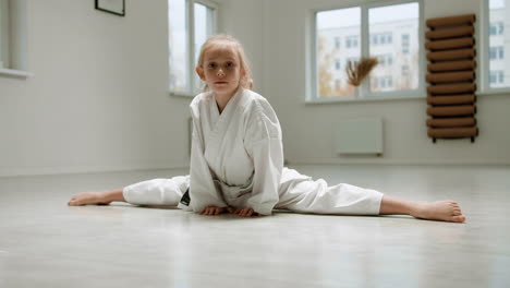 girl in white kimono in martial arts class