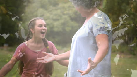 animation of tree over senior caucasian woman sitting in wheelchair and her granddaughter