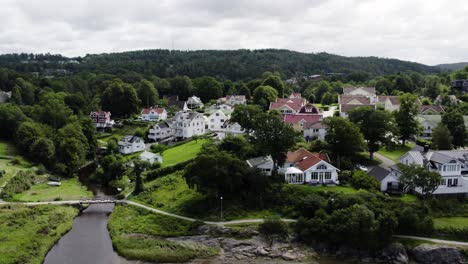 ljungskile town with traditional swedish houses near a river, cloudy day, aerial view