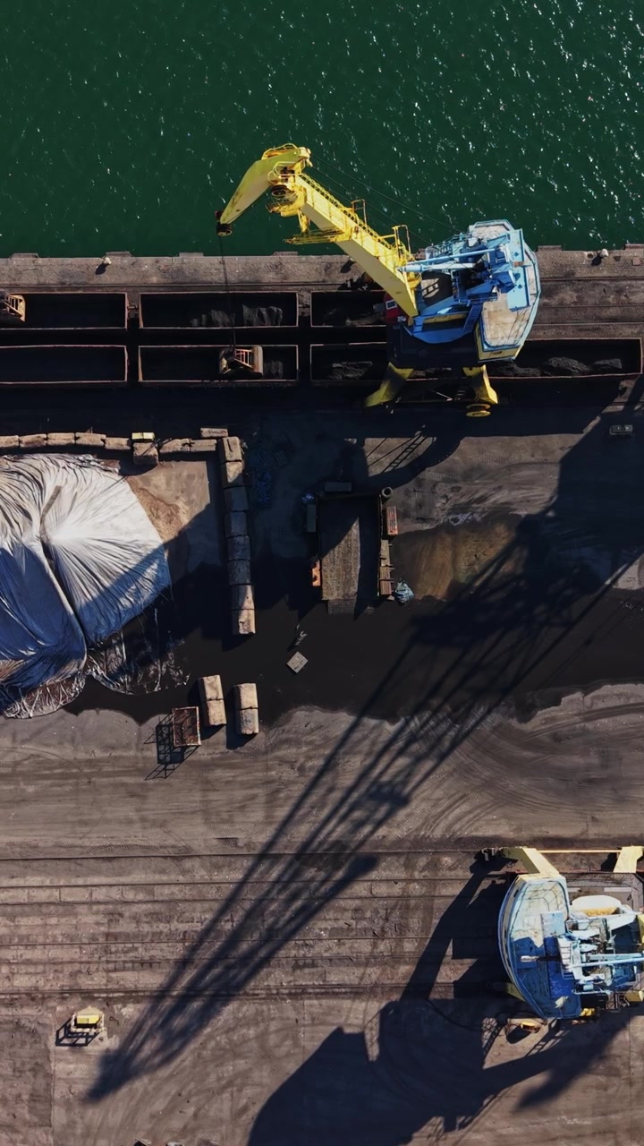 Top view of yellow port cranes loading cargo in Burgas