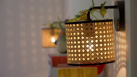 slow revealing shot of patterned wicker lampshades hanging in a bedroom