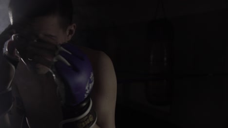 a male boxer is striking at the camera