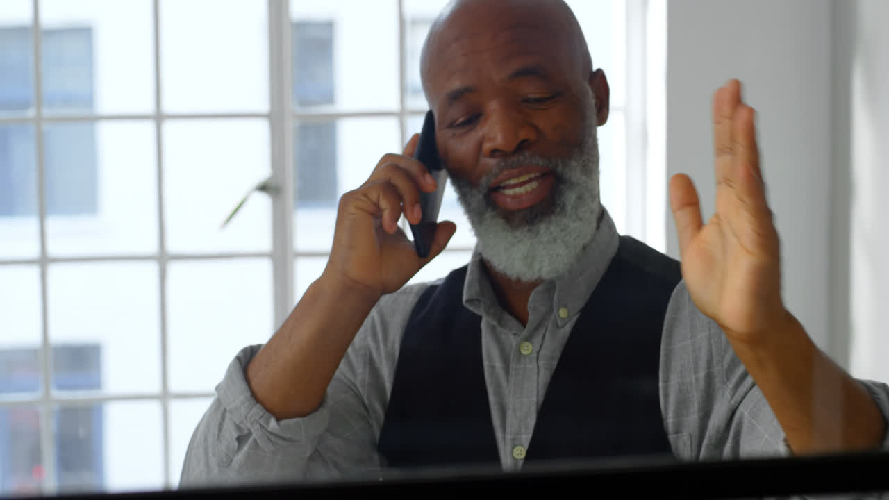 Businessman talking on mobile phone in the office 4k
