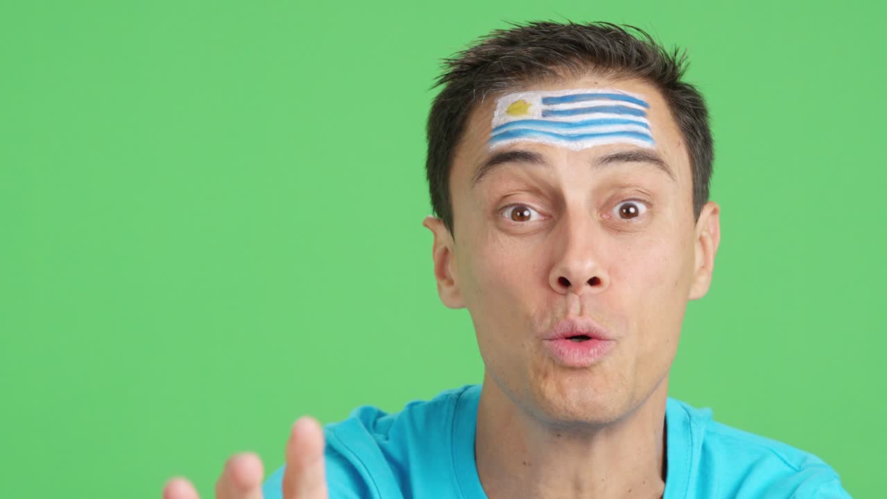 Close up of a man supporting uruguayan team