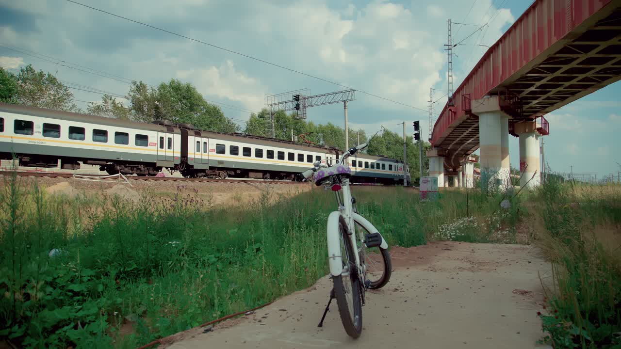 A slow running train in the Railway and a white bike