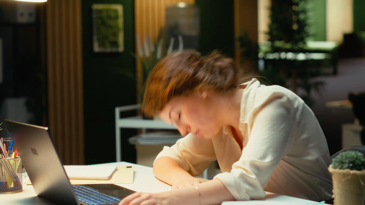 Vertical Video General manager in a dark office at midnight struggles to stay awake