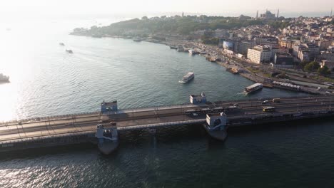 orbiting drone shot above galata bridge in istanbul along the golden horn
