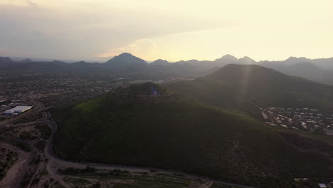 Birdseye-view-of-A-Mountain-in-Tucson,-Arizona-with-sun-rays-illuminating-mountain