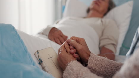 Holding-hands,-bible-and-senior-women-in-hospital