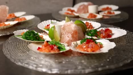 chef preparing scallops with salmon and seaweed