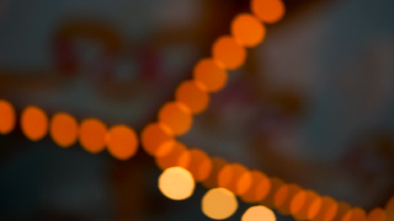 Bokeh light on the Ferris wheel at the christmas night, fast the speed