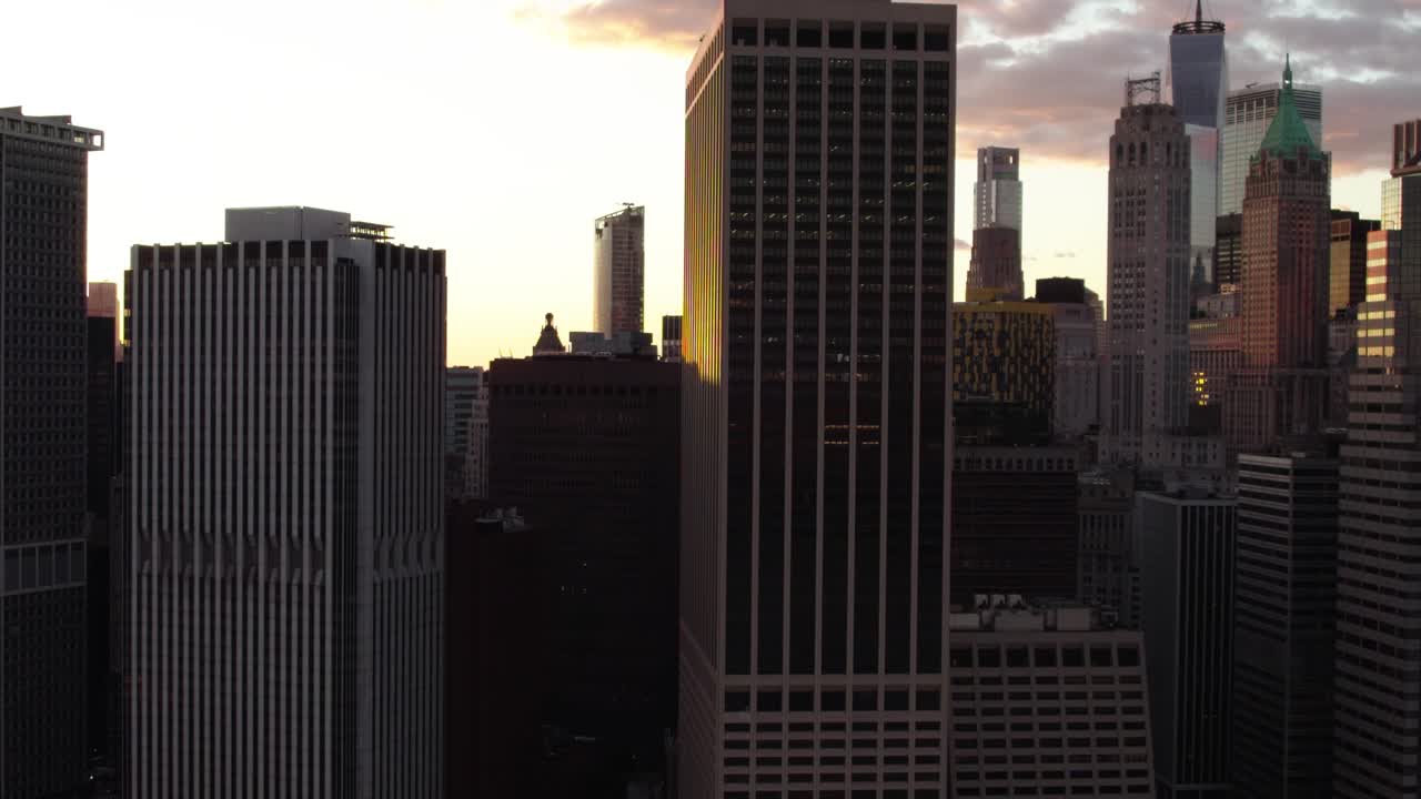Tall skyscrapers in Manhattan, backlit by the sunset in New York, USA - Aerial view