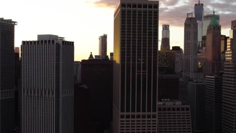 tall skyscrapers in manhattan, backlit by the sunset in new york, usa - aerial view