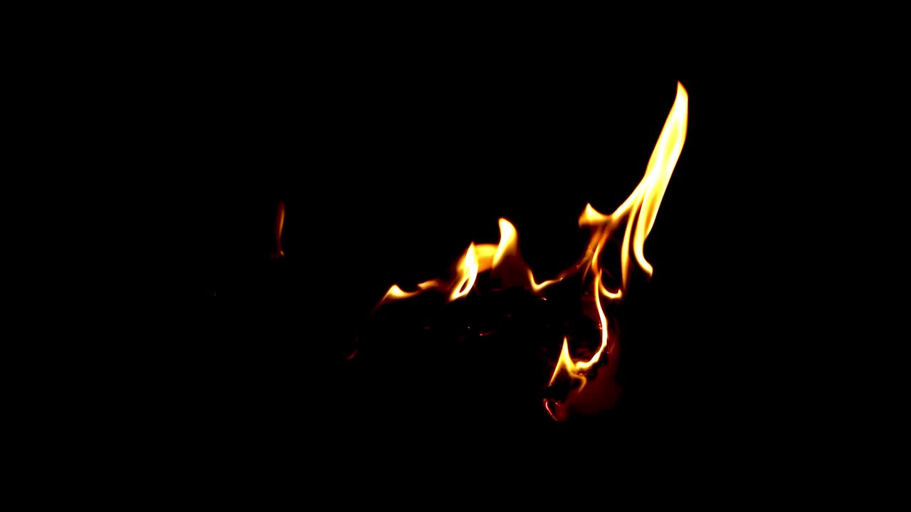 Burning white paper with vibrant intense fire on isolated black background