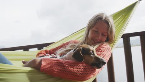 caucasian couple spending time at home together, playing with dogs