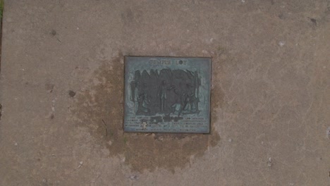 An-ascending-drone-starting-plaque-and-the-temple-lot-Independence-Missouri-with-the-Church-of-Christ,-Community-of-Christ,-Remnant-and-The-Church-of-Jesus-Christ-of-Latter-day-Saints