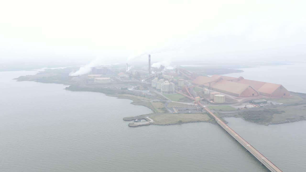 Aughinish alumina refinery in limerick, ireland on a foggy day over the water , aerial view