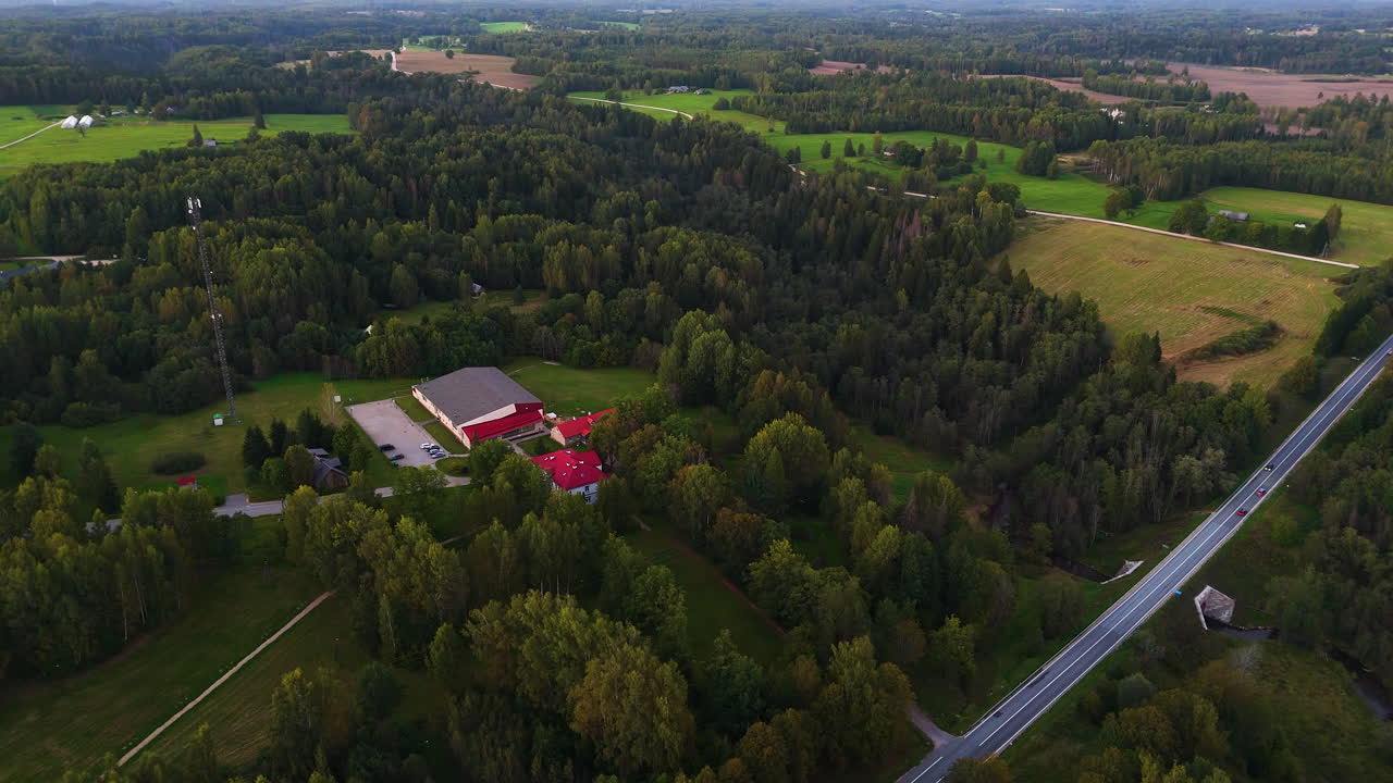 Aerial View Of A Rural Countryside School District Surrounded By Farm Fields In Latvia, Northeastern Europe.