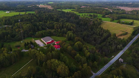 aerial view of a rural countryside school district surrounded by farm fields in latvia, northeastern europe.