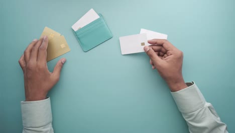 top view of man holding many credit card