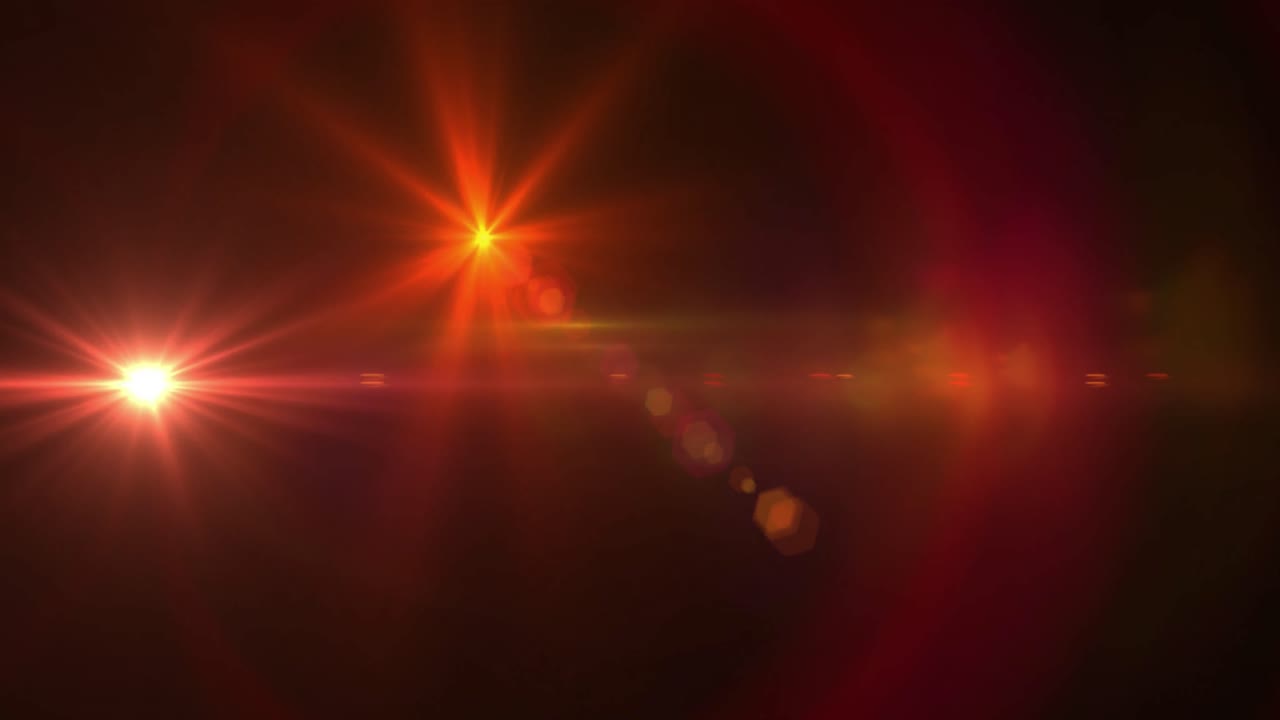 manchas rojas de luz contra un fondo negro