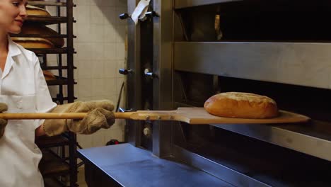 female baker baking fresh bread