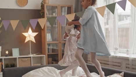 mixed-race girls whirling on bed