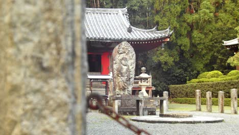 slide shot of an old stone statue in kyoto, japan 4k slow motion