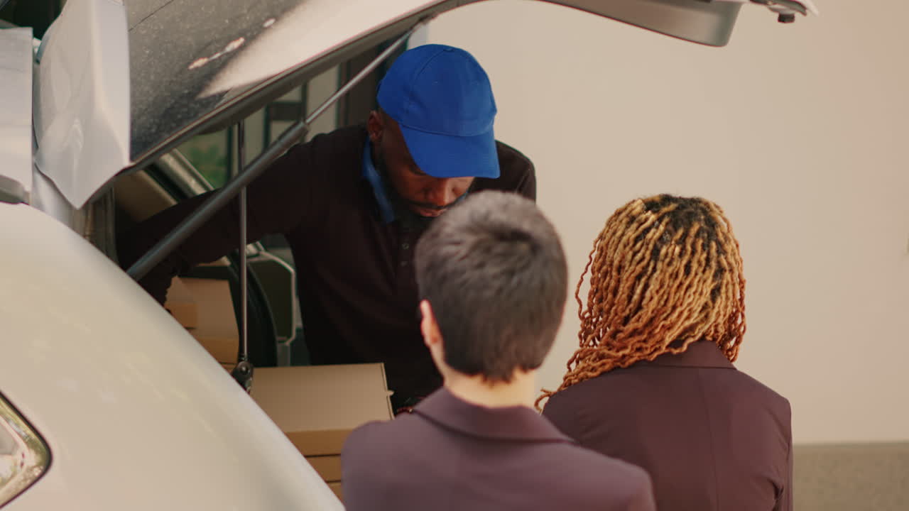 Delivery Man Unloading Packages from Car