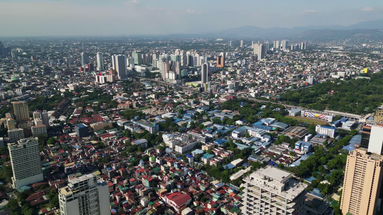 Aerial view of a heavily populated metropolitan area and buildings during daytime at Quezon City, Metro Manila, Philippines.