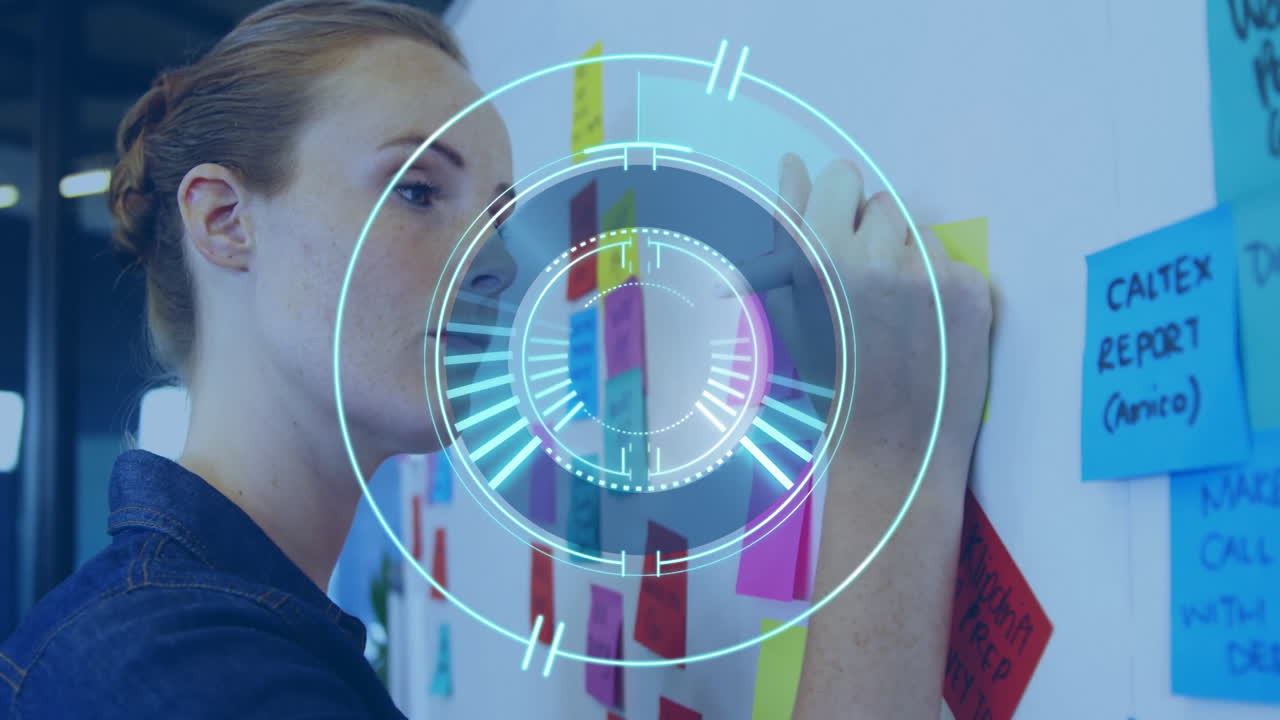 Woman organizing colorful sticky notes with digital interface animation overlay