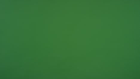 cu two people in suits shaking hands on green screen