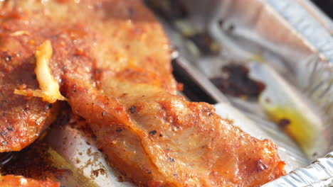 Close-up-of-pork-neck-meat-grilled-on-an-aluminum-tray