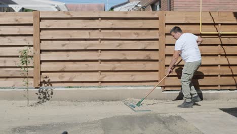 gardener laying a roll of natural lawn turf