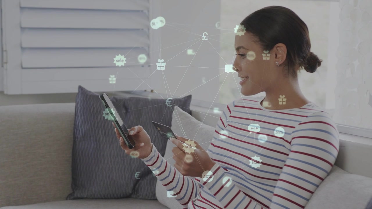 Woman tapping smartphone, holding card on sofa, animating currency icons and confirming payment