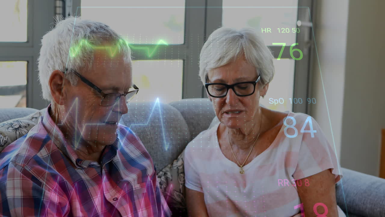 Animation of cardiograph over senior caucasian couple measuring blood pressure