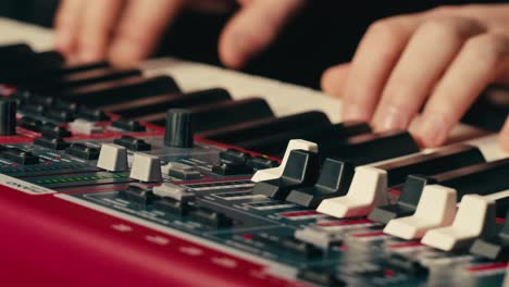 Close Up of keyboard Player Hands Playing Rock Music with keyboard at the Concert in studio, rehearsal room, macro play on synthesizer.