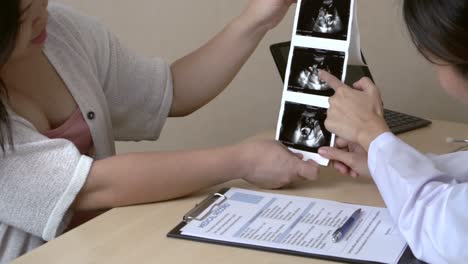 pregnant woman and gynecologist doctor at hospital