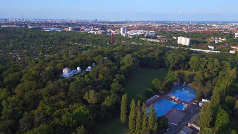 nice aerial top view flight berlin city public swimming pool germany in europe, summer day 2023