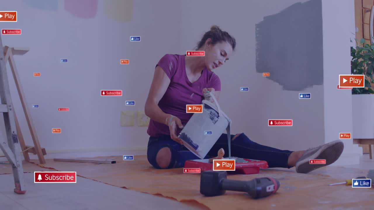 Painting wall, woman surrounded by animation of social media play and subscribe icons