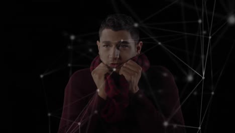 animation of a mixed race man wearing a scarf with white connection icons floating in foreground