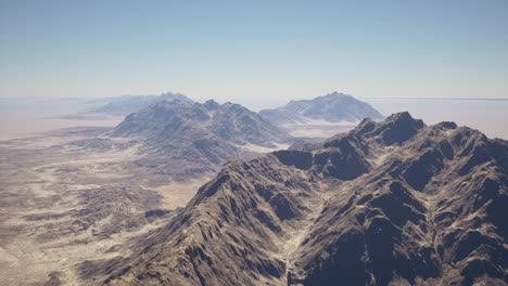 aerial view of a majestic mountain range in a vast desert