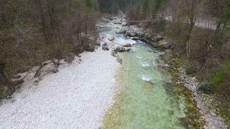 aerial - flying low above the turquoise color river