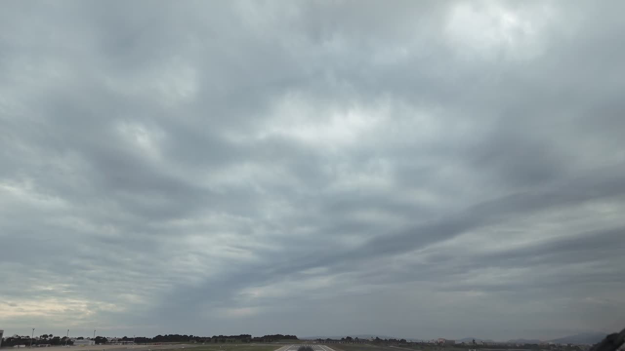 an immersive pilot’s view as seen from a jet cockpit in a real time takeoff from an isolated runway, climbing toward a cloudy sky.