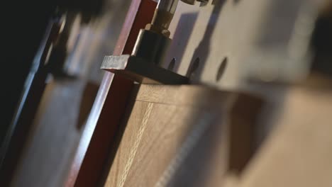 Closeup-Of-Wood-Being-Clamped-In-A-Woodworking-Manufacturing-And-Assembly-Plant